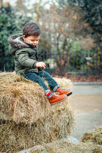 Rear view of boy wearing hat on land