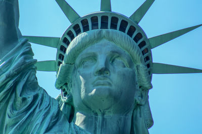 Low angle view of statue against blue sky