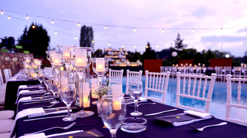 Chairs and tables at restaurant against sky