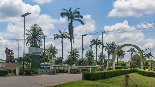 Panoramic view of palm trees and buildings against sky