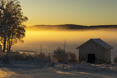 Lake bysjön in grangärde sweden when the fog is close to ground and the sun shines through the fog