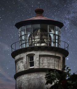 Low angle view of lighthouse and stars at night