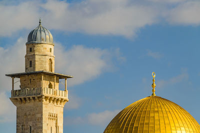 Low angle view of bell tower against sky