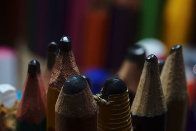 Close-up of pencils in bottles
