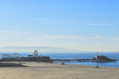 Scenic view of beach against blue sky