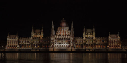 Illuminated city against sky at night