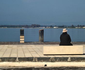 Man on sea shore against sky