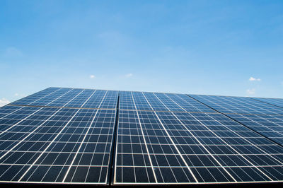 Low angle view of solar panels against sky