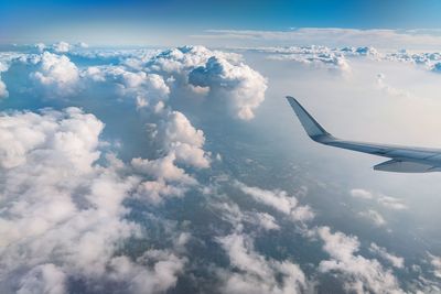 Aerial view of cloudscape and land against sky