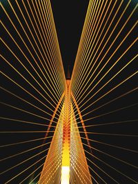 Low angle view of illuminated bridge against sky at night