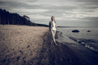 Woman on beach against sky