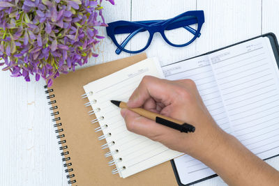High angle view of woman reading book on table