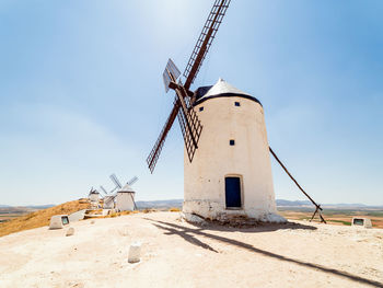 Traditional windmill on land against sky