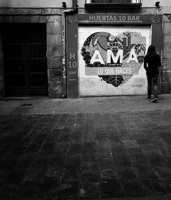 Man standing by wall in city