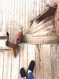 Low section of man standing on wood paneling