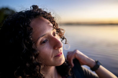 Side view of young woman drinking water