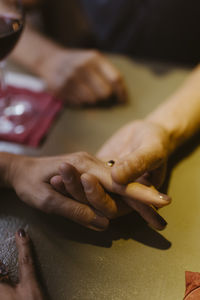 High angle view of mature couple holding hands at restaurant