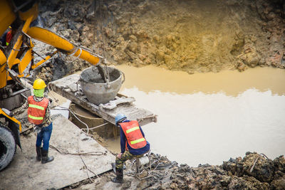 High angle view of people working on rock