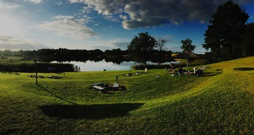 Scenic view of golf course on field against sky