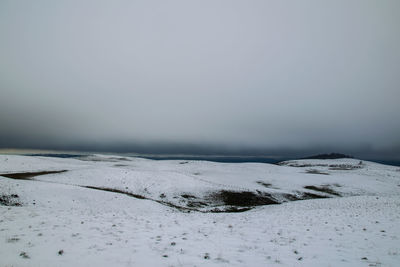 Snow covered shore against sky
