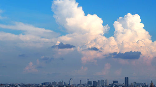 Aerial view of cityscape against dramatic sky