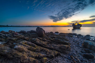 Scenic view of sea against sky at sunset