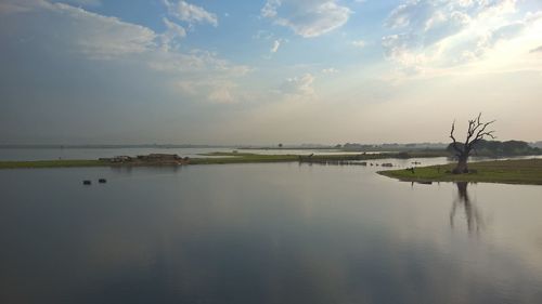 Scenic view of lake against sky during sunset