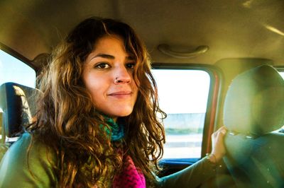 Portrait of young woman in car