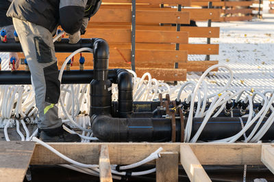 Worker building pipeline system for low temperature maintenance. preparing of outdoor skating rink