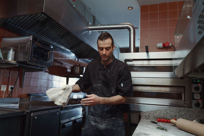 Chef swirling pizza dough