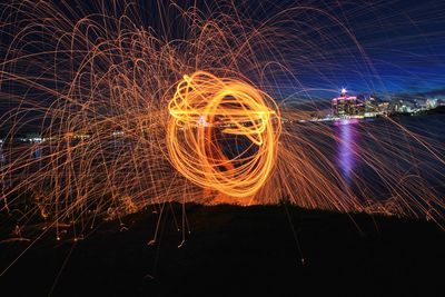 Close-up of ferris wheel against sky at night