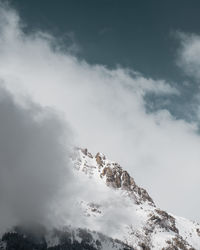 Low angle view of snowcapped mountain against sky