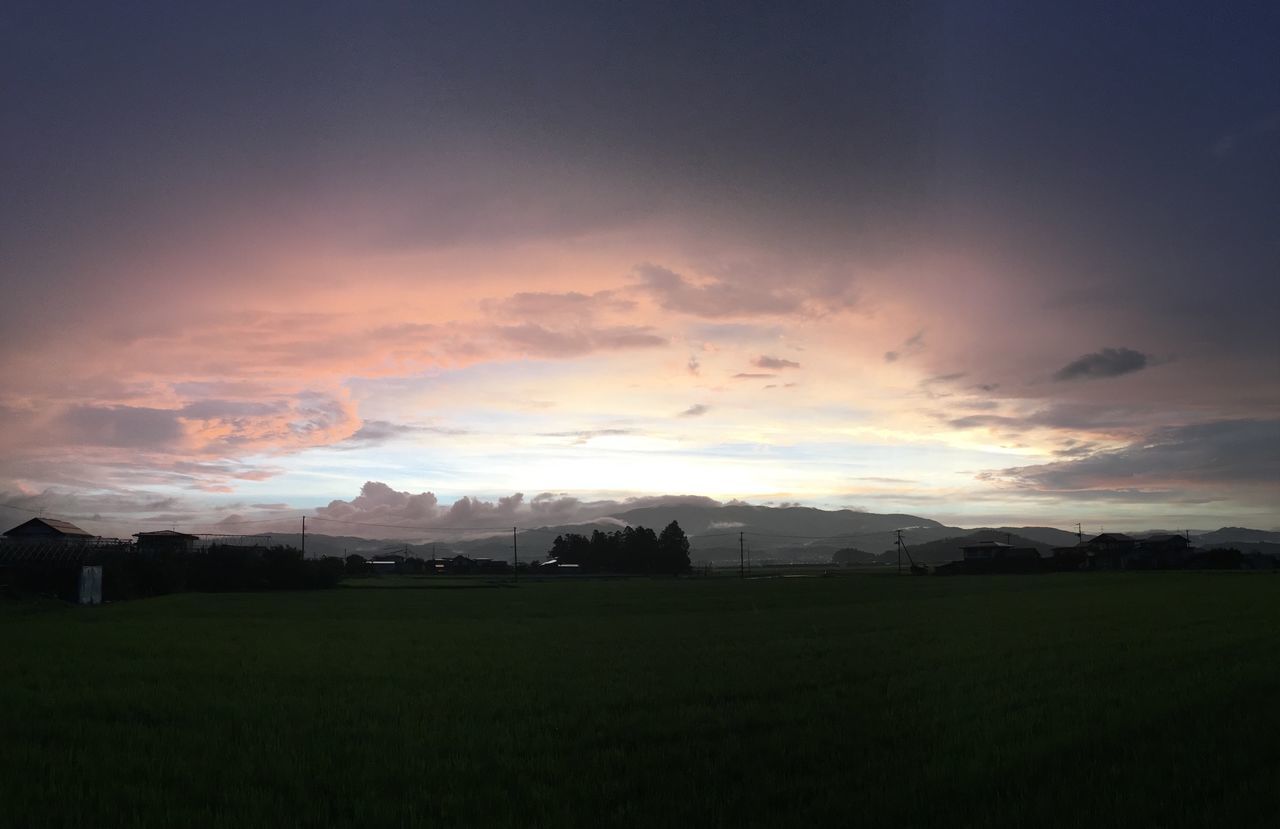 landscape, field, tranquil scene, sky, tranquility, sunset, scenics, beauty in nature, nature, cloud - sky, grass, rural scene, idyllic, sun, grassy, cloud, horizon over land, cloudy, outdoors, no people, growth, sunbeam, non-urban scene, remote, weather, green color