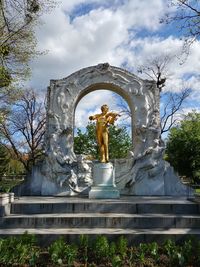 Low angle view of statue in park against sky