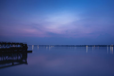 Pier over sea against sky at sunset