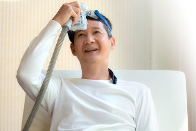 Male patient with medical oxygen equipment relaxing at hospital