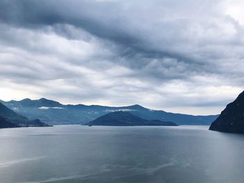 Scenic view of sea and mountains against sky