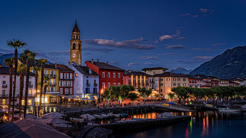 View of illuminated buildings in city at dusk