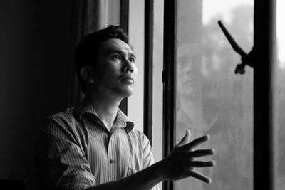 Man standing by window