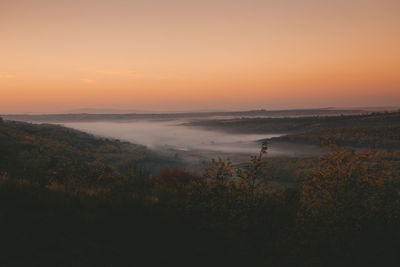 Scenic view of landscape against sky during sunset