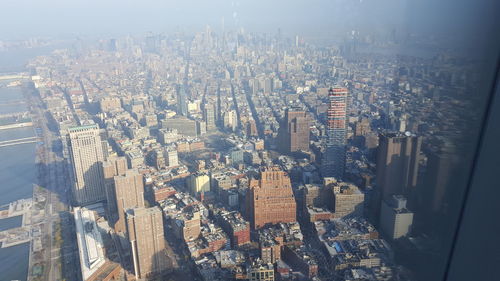 Aerial view of cityscape seen through airplane window