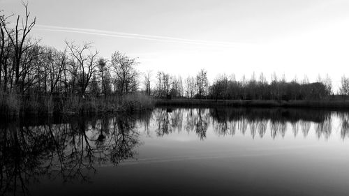 Scenic view of lake against sky at sunset