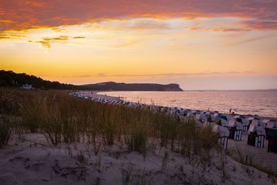 Scenic view of beach against sky during sunset