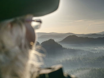 Midsection of man on mountain against sky