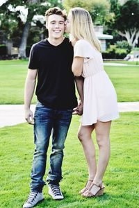 Full length of happy woman standing in park