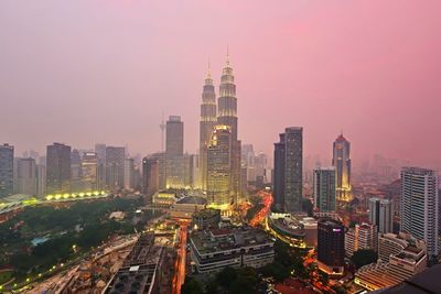 Aerial view of buildings in city against sky