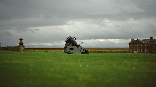 Built structure on field against sky