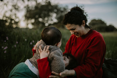 Cheerful mother with kids outdoors