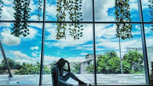 Reflection of person sitting in glass window