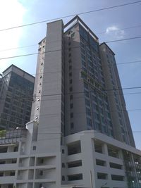 Low angle view of office building against sky